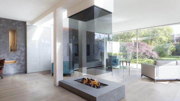 The 870 suspended glass fireplace with tinted glass and white plaster finish around the top