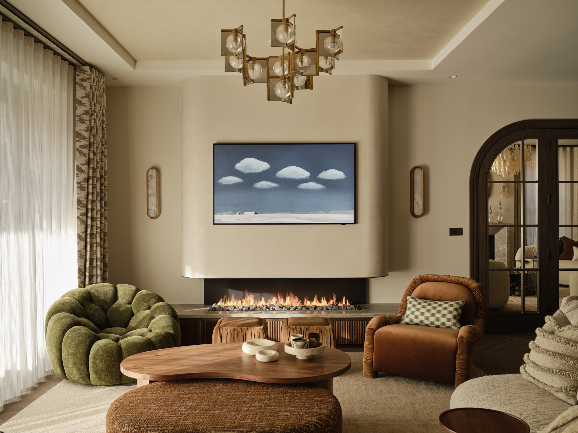 Bespoke linear gas fireplace with fluted oak base, stone surround, lava rock fuel bed and smooth curved plastered flue by Modus Fireplaces