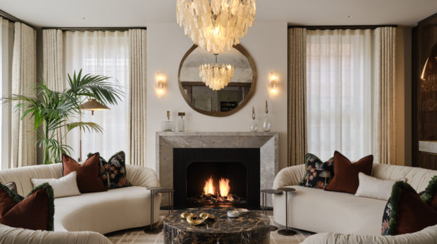 Bespoke open-front gas fireplace with marble mantel surround and fluted steel interior in a contemporary living space by Modus Fireplaces